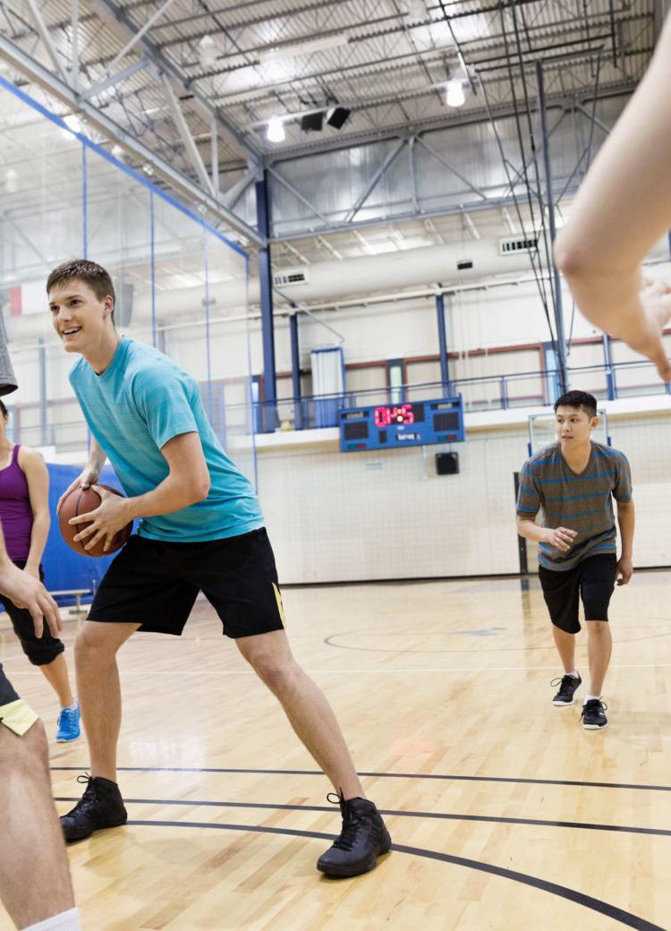several students play intramural basketball